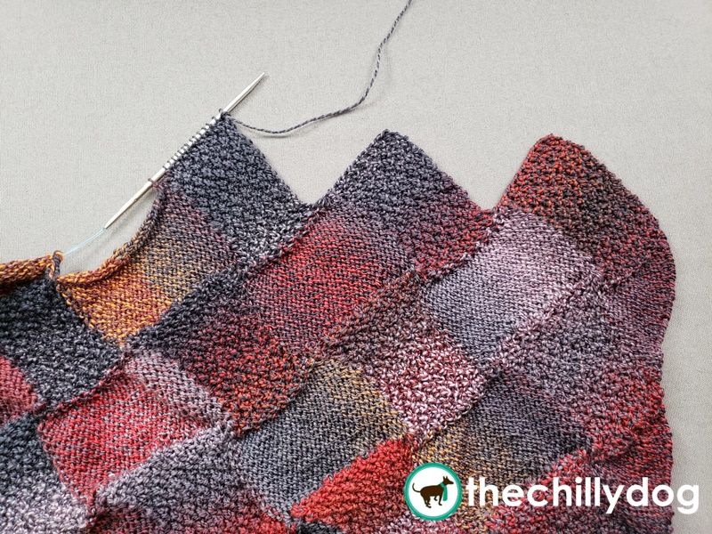 Finishing an entrelac piece with end rectangles creates a zig-zagged edge.